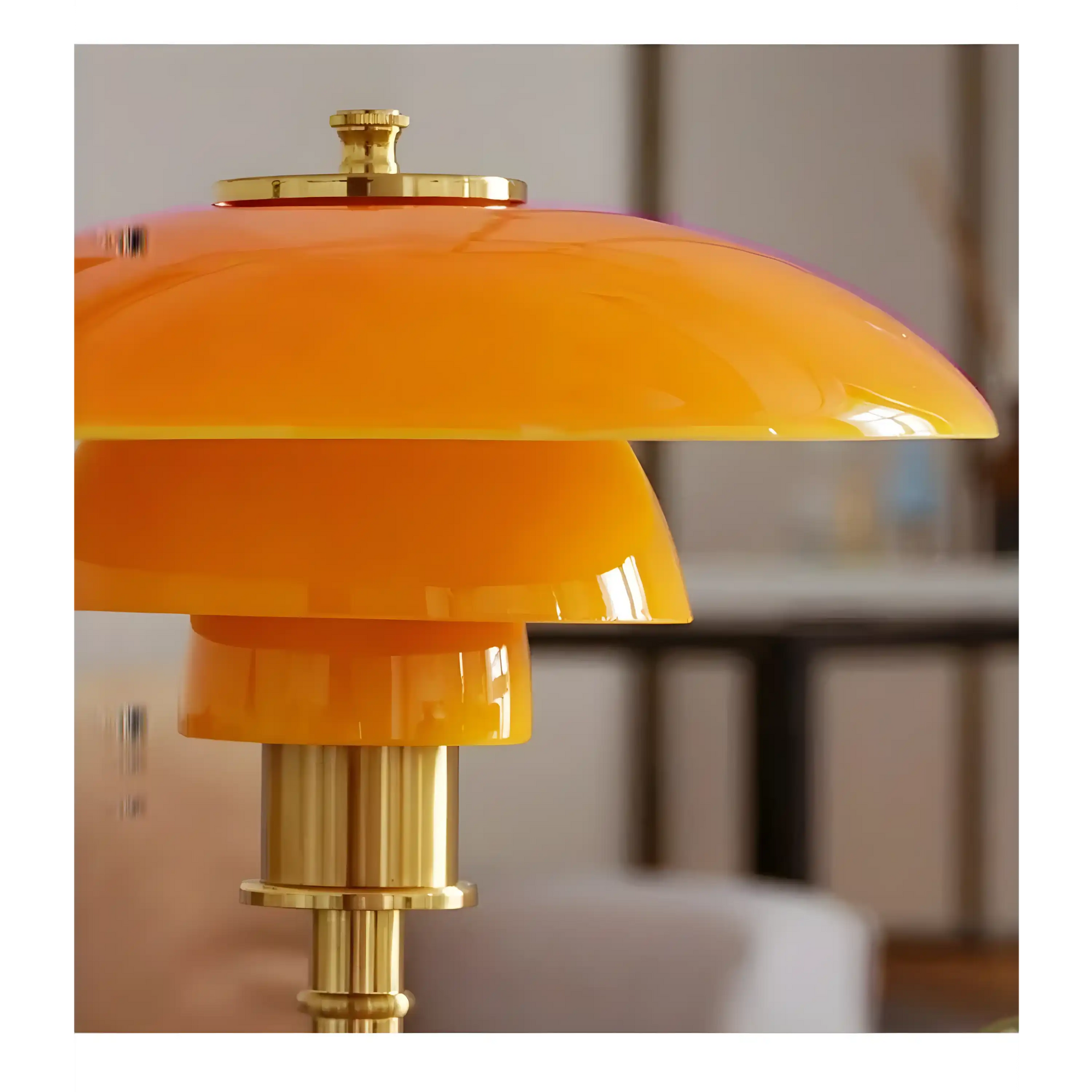 Bright orange and gold table lamp with a layered, dome-shaped shade.