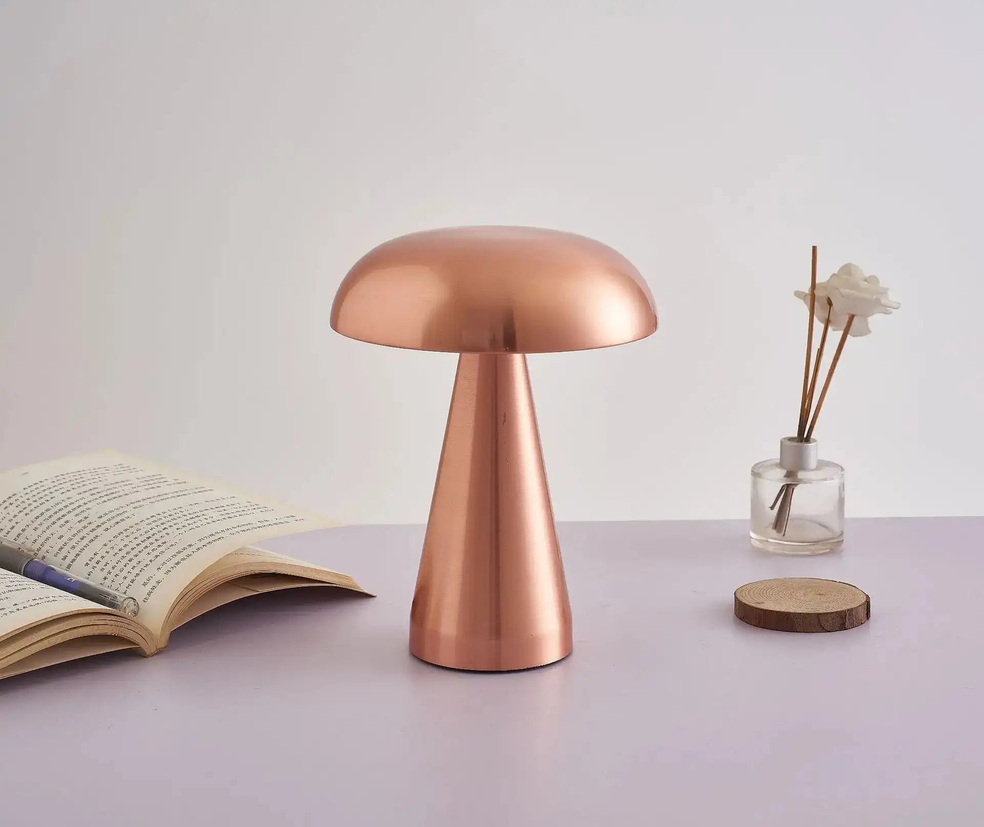 Copper-colored mushroom-shaped table lamp with a smooth, metallic finish.