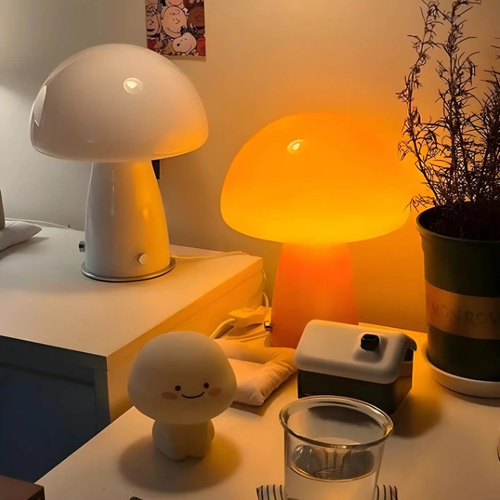 Mushroom-shaped table lamps with glowing white and orange domes.