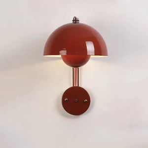 Red dome-shaped wall sconce with a metallic stem and circular base.