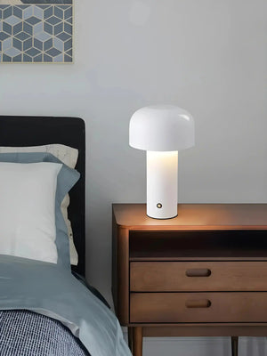 Modern table lamp with a white dome-shaped shade atop a cylindrical base.