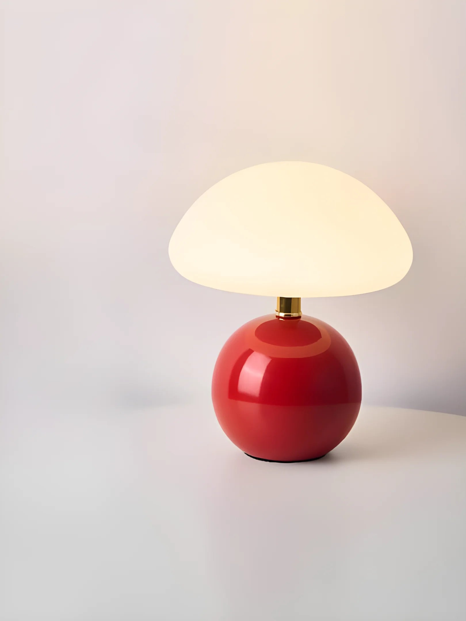 Red spherical table lamp with a white dome-shaped shade.